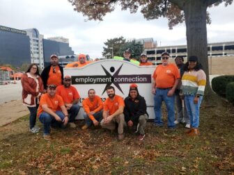 Union workers pose in front of the Employment Connection sign