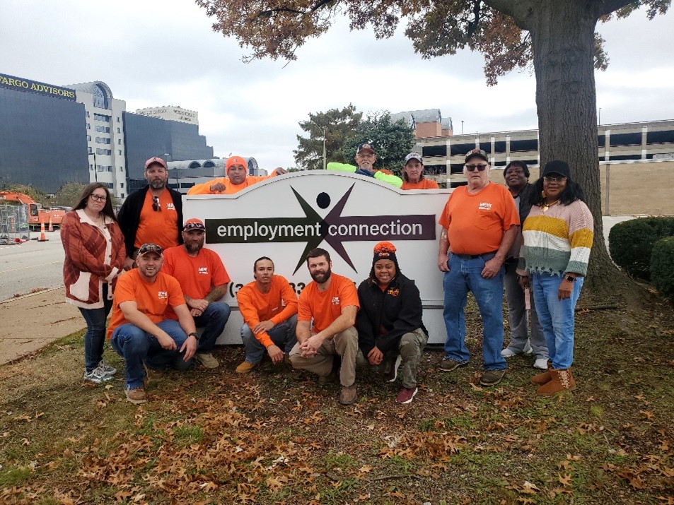 Union workers pose in front of the Employment Connection sign